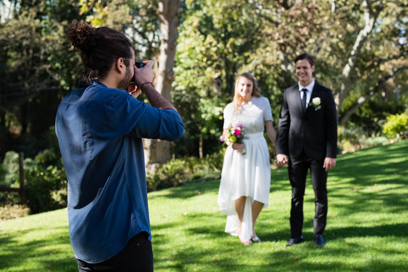photographer-taking-photo-of-newly-married-couple-2023-11-27-05-09-45-utc